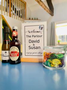 a bottle of beer and a bowl of food on a table at The Parlour in Hexham