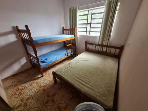 Ένα ή περισσότερα κρεβάτια σε δωμάτιο στο Ohana Casa Boraceia
