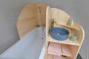 a wooden bathroom with a sink and a shower at Bulle Ecureuil in Quarré-les-Tombes