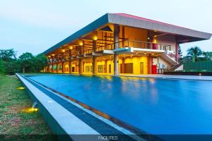 a building with a swimming pool in front of it at Carlsen Residence in Colombo