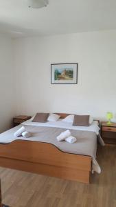 a bedroom with a large bed with two towels on it at Apartments Irena in Božava
