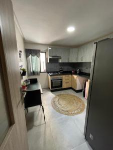 a small kitchen with a table and a stove at Superbe Appartement Bouskoura in Bouskoura