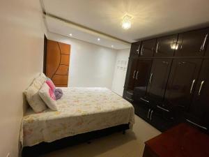 a small bedroom with a bed and a cabinet at Cantinho Almeida in Alto Paraíso de Goiás
