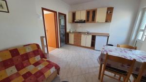 a kitchen with a table and a dining room at Apartments Irena in Božava