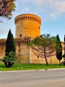 a large castle with a tree in front of it at La casetta di Giulio II in Ostia Antica +33 photos