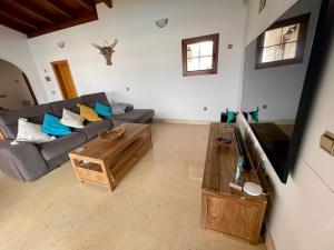 a living room with a couch and a coffee table at Stunning Villa Amanecer in Corralejo