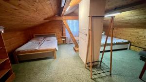 a bedroom with two bunk beds in a wooden cabin at Apartmán Deštné v Orlických horách 58 in Deštné v Orlických horách