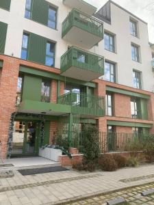 a building with green balconies on the side of it at Luxury by The Lake Ap 25 in Sibiu