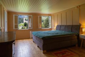 a bedroom with a bed and two windows at Casa Dorino - Casa di vacanza ideale per famiglie in Rodi