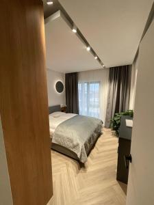 a bedroom with a bed and a large mirror at Luxury by The Lake Ap 25 in Sibiu