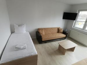 ein Schlafzimmer mit einem großen Bett und einem Sofa in der Unterkunft Ferdimesse Apartments 2 in Köln