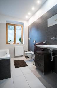 a bathroom with a sink and a toilet at Dom z ogrodem blisko centrum in Poznań