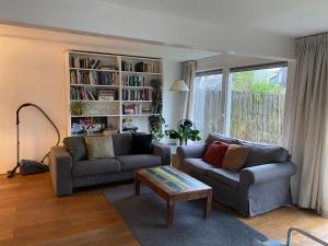 a living room with two couches and a coffee table at Lovely family house nearby Amsterdam and Schiphol in Almere