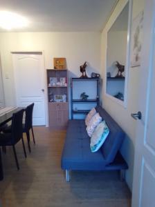 a living room with a blue couch and a table at 2BR Casa Mia Sanremo Oasis Cebu in Talisay +29 photos