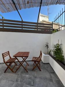 a patio with two chairs and a table on a roof at Casaki38 in Heraklio