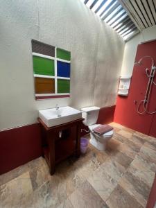 a bathroom with a sink and a toilet at UDEE Cozy Hotel in Chiang Mai
