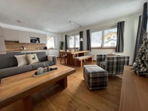 a living room with a couch and a table at Alp Apart Niederthai in Umhausen
