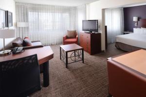 a hotel room with a bed and a television at Sonesta ES Suites Dallas Central Expressway in Dallas