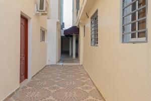an alley with a tiled floor in a building at Premium Single Room in Corales del Sur in La Viva +2 photos