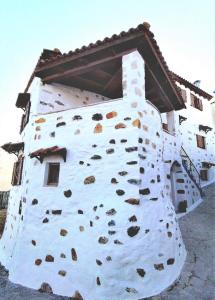 un edificio que está hecho de rocas en Afroditi Traditional Villa, en Yiannioú