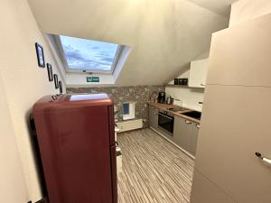 a kitchen with a refrigerator and a window at Apartment Zum roten Fuchs inkl. Parkplatz in Erfurt