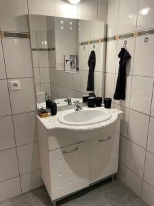 a bathroom with a sink and a mirror at La Maringote in Cerisy-la-Forêt