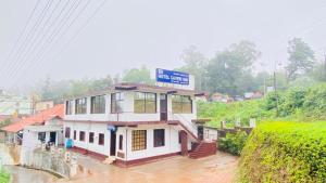 a building with a sign on top of it at Hotel Caveri Inn in Madikeri