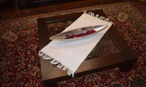 a plate on top of a white napkin on a table at Afonsos House & Rooms in Videmonte