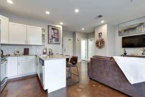 a kitchen and living room with a couch in the middle at Stunning Nashville Condo Minutes from Broadway in Nashville
