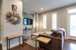 a living room with a couch and a tv at Stunning Nashville Condo Minutes from Broadway in Nashville