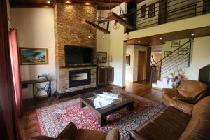 a living room with a couch and a fireplace at Afonsos House & Rooms in Videmonte