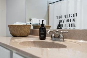 a bathroom sink with a bottle of soap on it at Stunning Nashville Condo Minutes from Broadway in Nashville +23 photos