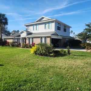 a house with a lawn in front of it at Apartment in Ponte Vedra Beach in Ponte Vedra Beach