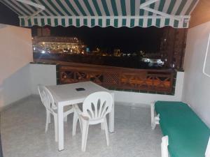 a table and chairs on a balcony with a view at Victoria Court 2, Los Cristianos in El Guincho
