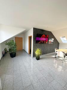 an office lobby with a table and a sign on the wall at Casa Nero in Leimen