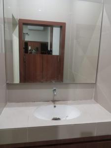 a bathroom with a sink and a mirror at Griya Sambilegi in Yogyakarta