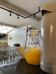 a blender sitting on a counter with an orange juice at Pousada Vitória da Vila in Brasília