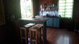 a kitchen with a counter and stools in it at Casa da Lagoa in Florianópolis