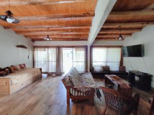 a large living room with a couch and a tv at Casona Alma en Calma San Rafael in San Rafael