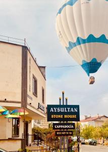 a hot air balloon is flying over a store at Aysultan Stone House in Uchisar
