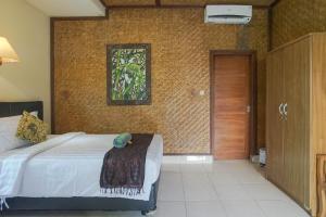 Postel nebo postele na pokoji v ubytování Ubud Kerta City Hotel