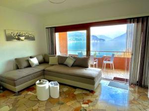 a living room with a couch and a view of the ocean at Ferienwohnung Studio Belvedere in Brezzo