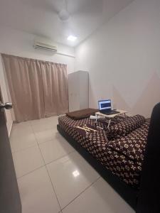 a bedroom with a bed with a laptop on it at Oug Parklane 3br2b Spacious House for a big family in Kuala Lumpur