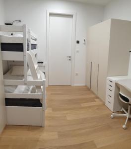 a white room with a bunk bed and a desk at HIRUNDO- villa with saunas and hot tub 