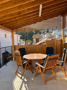 a wooden table and chairs on a patio at Eftis - Renovated Traditional House in Omodos