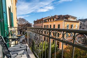 a balcony with a table and chairs and buildings at Calma Luxury Rooms in Split