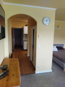um quarto com uma cama e um relógio na parede em Kati Appartement em Bad Hönningen