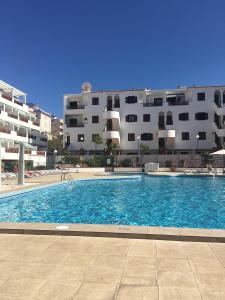 a large swimming pool in front of a building at Victoria Court 2, Los Cristianos in El Guincho