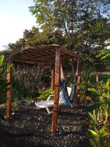 a hammock in a wooden shelter in a garden at Hostal Casa Las Lajas in Las Lajas