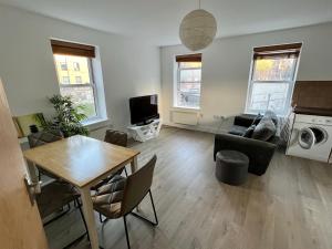 a living room with a table and a couch at 221 Clapham Road Apartments in London